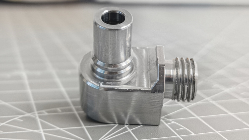 Finished multi-feature small metal part machined on dual-turret CNC machine with indexing chuck Finished multi-feature small metal part machined on dual-turret CNC machine with indexing chuck